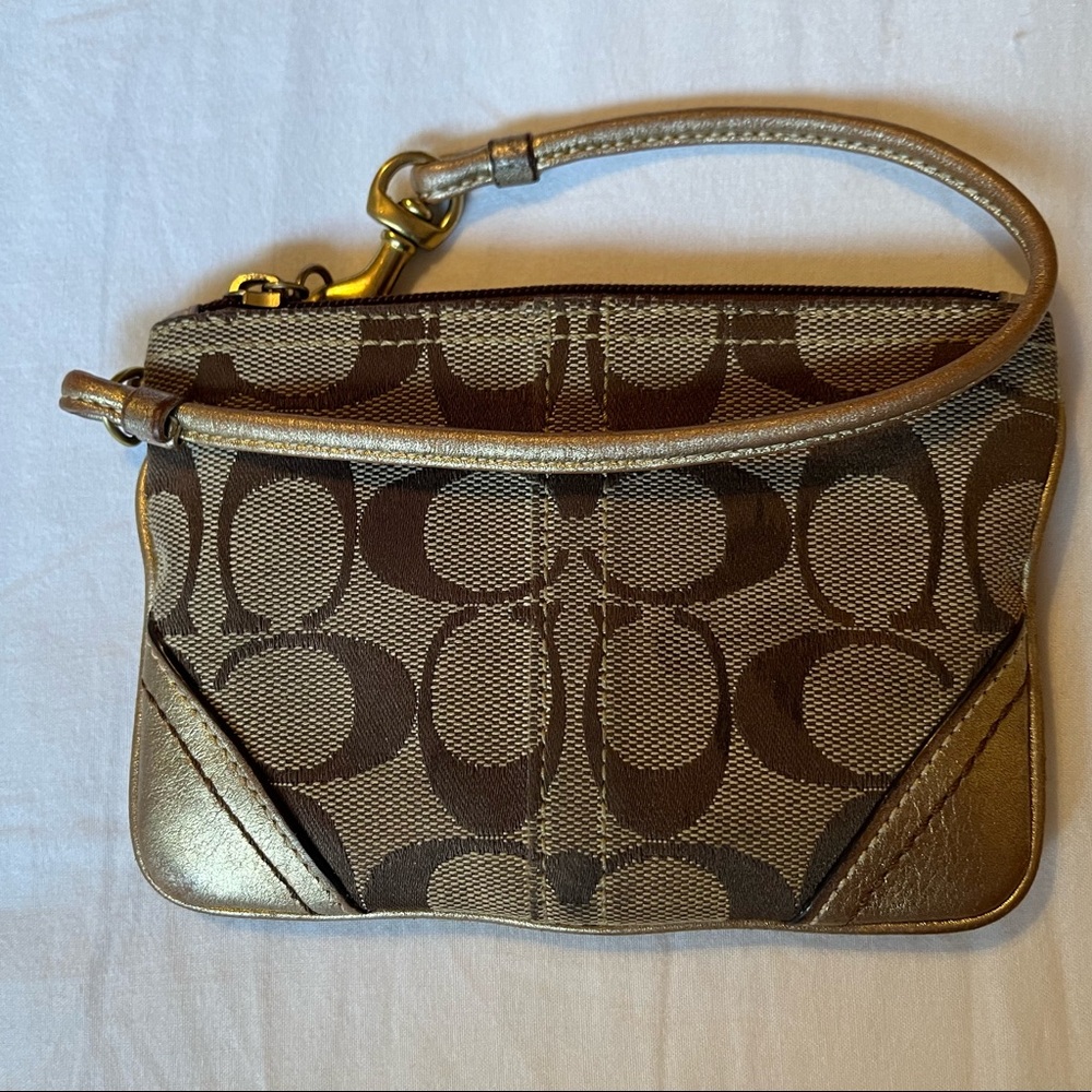 Gold and brown Coach wristlet